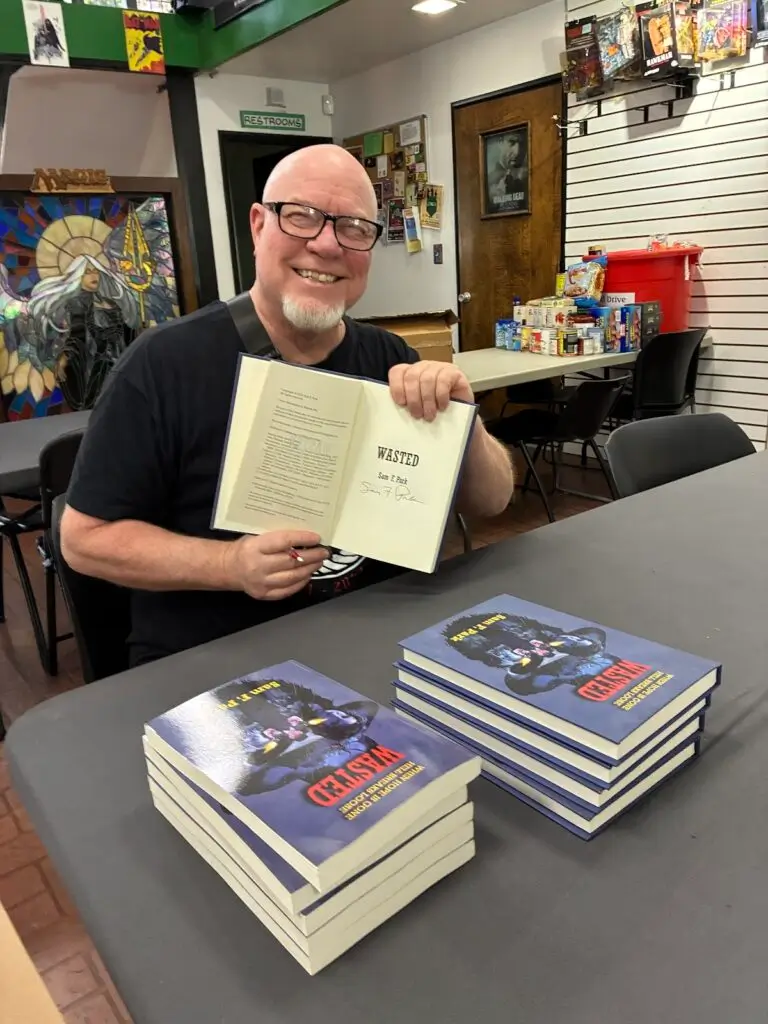 At a Dark Delicacies bookstore pop-up event, signing books.